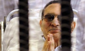 Former Egyptian President Mubarak sits inside a cage in a courtroom at the police academy in Cairo