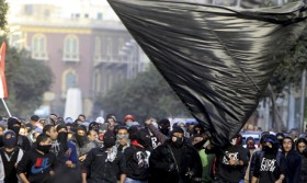 Members of the Black Bloc are seen during the protest in Tahrir Square in Cairo