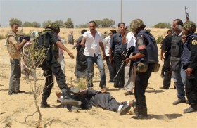 Egyptian security forces arrest suspected militants after a firefight at the al-Goura settlement in Egypt's north Sinai region, near the border with Israel