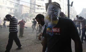 A member of the Muslim Brotherhood and supporter of ousted Egyptian President Mohamed Mursi wears a makeshift gas mask during clashes in Cairo