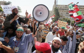 Supporters of Egyptian President Mursi shout slogans during protest around Raba El-Adwyia mosque square in Cairo