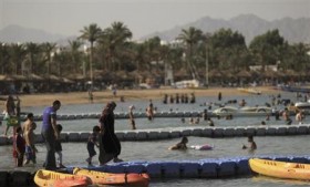 People walk at the beach at the Red Sea resort of Sharm el-Sheikh in the South Sinai governorate