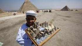 A child vendor waits for tourists to sell them souvenirs at the Giza Pyramids, on the outskirts of Cairo