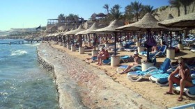 Tourists are seen at a beach with a swimming ban at the Red Sea resort of Sharm el-Sheikh