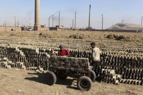 Brick layers works at a brick factory on the outskirts of Giza governorate