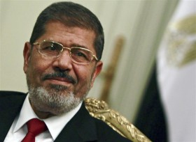 Egypt's first Islamist president Mohamed Mursi attends during his  meeting with Turkish Foreign Minister Ahmet Davutoglu at the presidential palace in Cairo